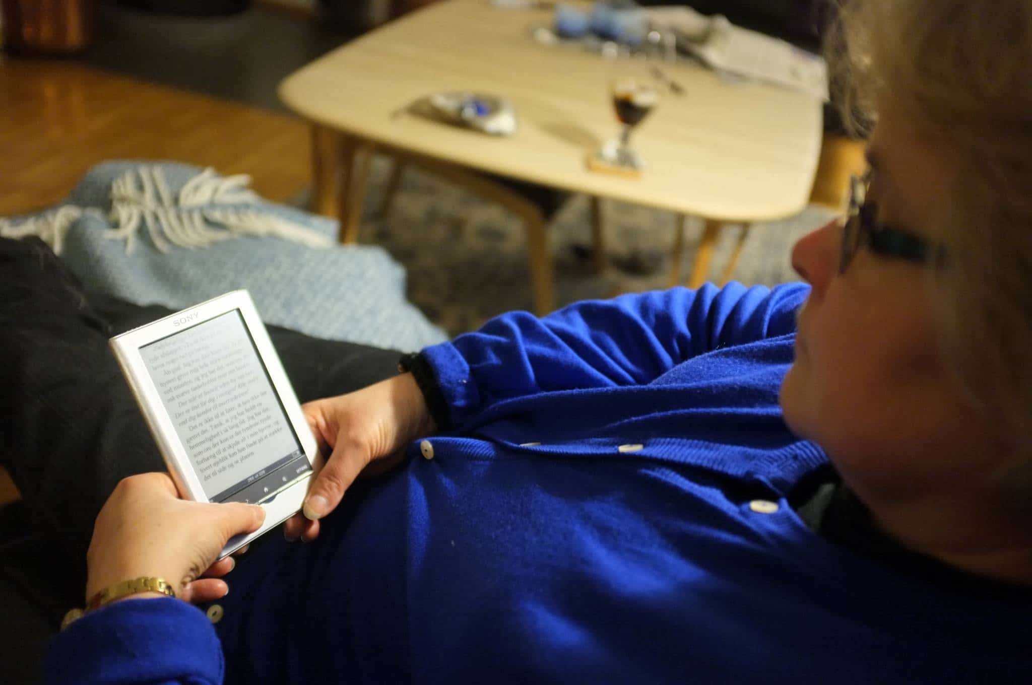 woman reading a book on an ereader