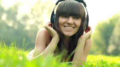 stockfootagewomanwithheadphoneslistentothemusicinthepark