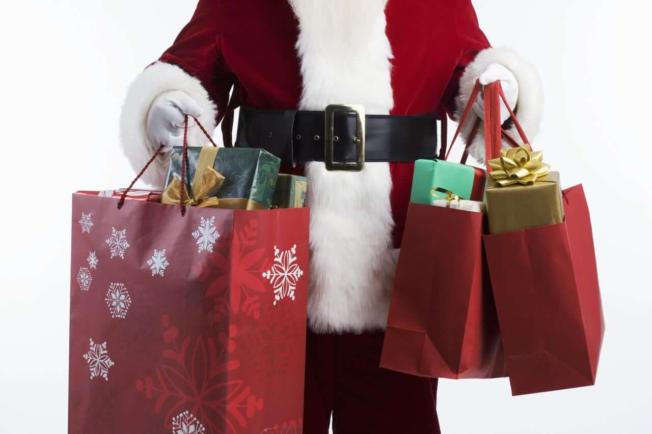 santa carrying shopping bags