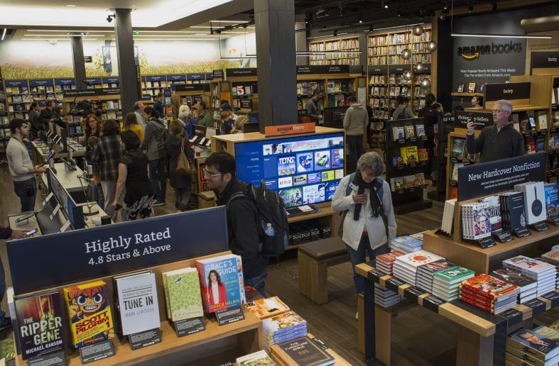 customers shop inside amazon books in seattle washington on tuesday nov 3 2015 the online retailer amazoncom inc opened its first brick and mortar location in seattle's upscale University Village mall. Photographer: Jasper Juinen/Bloomberg